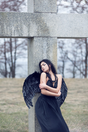 Black sad angel on the cemeteryの写真素材