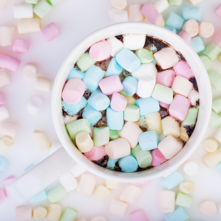 Lots of colorful marshmallow in the cup of coffeeの写真素材