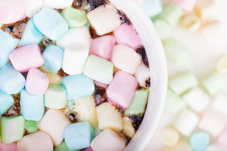 Lots of colorful marshmallow in the cup of coffeeの写真素材