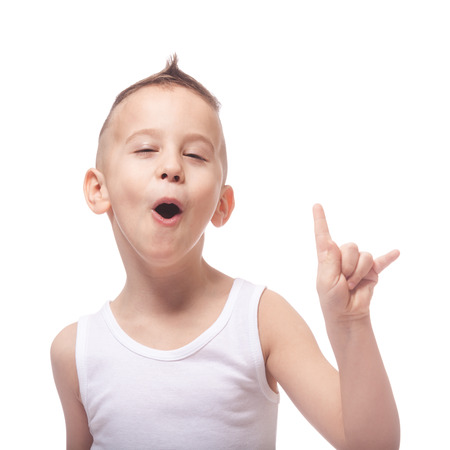Funny adorable rocking kid in a white shirt on isolated whiteの写真素材