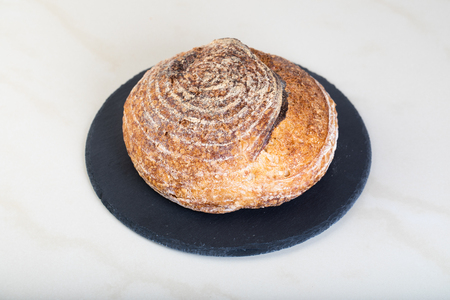 Wholewheat bread on black round plate