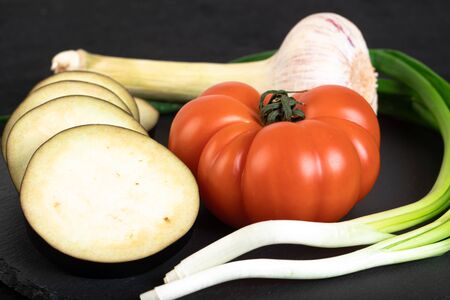 Assorted vegetables ob black stone plateの写真素材