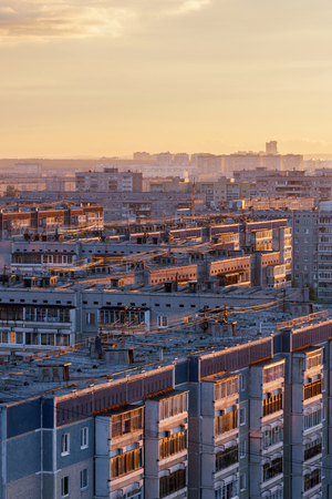 the setting sun casts light on slumsの写真素材
