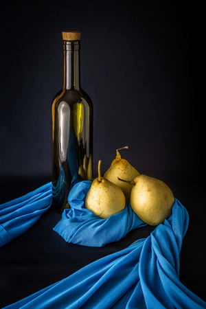 naturmort with bottle and three pears with blue cloth on a dark backgroundの写真素材