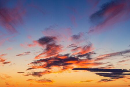 Sunset clouds colorful on the background of Smoking chimneys