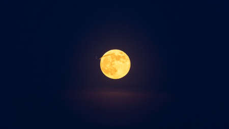 crescent moon shines red color