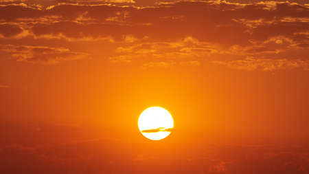 Sunset over the hills in clear weather gorizon cloudsの写真素材