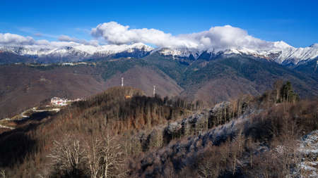 Peaks of a mountain range with cumulus clouds in Krasnaya Polyana