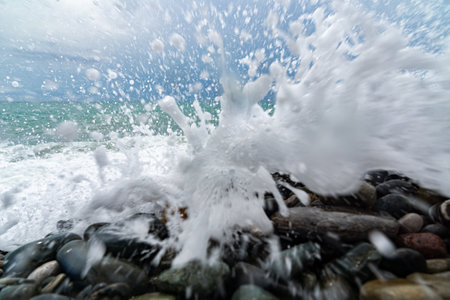 splash sunset in the surf on the rocks and splashesの写真素材