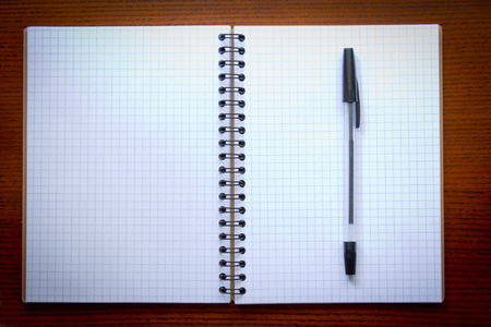 Pen and open Notepad on wooden backgroundの写真素材