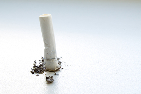 Cigarette butt closeup on gray backgroundの写真素材