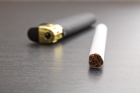 one sigarette and lighter closeup shotの写真素材