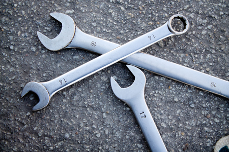 wrenches on a background of asphalt