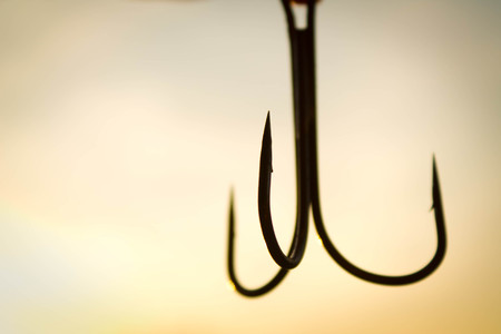 fishing hook closeup on evening sky backgroundの写真素材