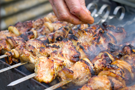 Grilled kebab cooking on metal skewer closeupの写真素材