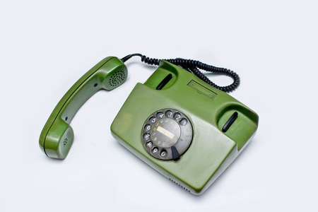 old green telephone on white backgroundの写真素材