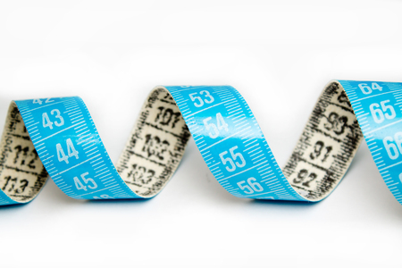 measure tape closeup on white backgroundの写真素材