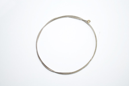 new electric guitar strings close up isolated on white background