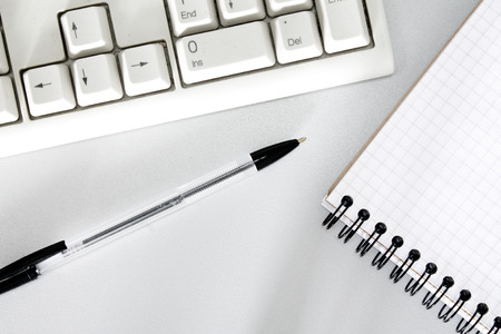 pen, keyboard and notebook closeupの写真素材