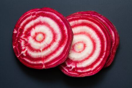 Sliced raw ââbeetroot on black backgroundの写真素材
