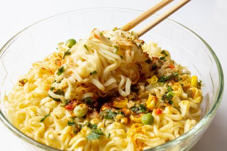 Instant noodles with spices in a plate on white backgroundの写真素材