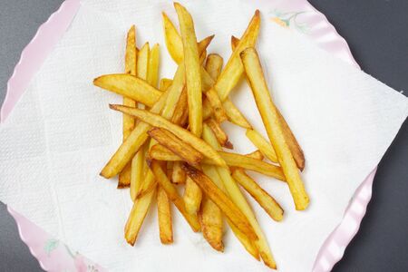 Fried potatoes close-up on a black background