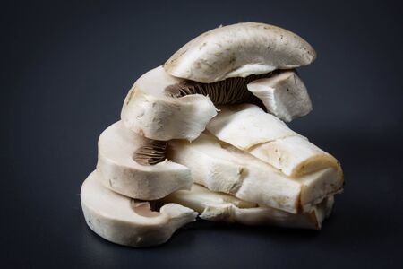 Sliced champignon on a dark background close-up