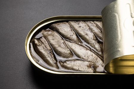 Open sprats can on dark background close upの写真素材