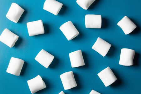 White marshmellow close up on blue backgroundの写真素材