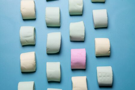 Multicolored marshmallows on a blue background