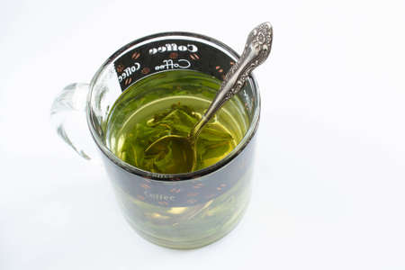 Tea with mint in a glass cup on white backgroundの写真素材