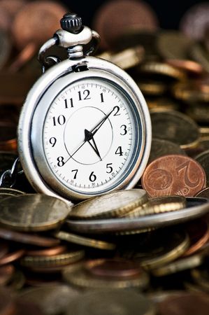 Time is money concept with clock and coinsの写真素材