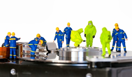 Team of technicians repair hard disk. Hard Drive repair conceptの写真素材
