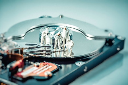 Group of criminalists inspecting hard drive. Technology concept. Macro photo.