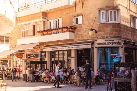 NICOSIA - APRIL 13 : People in restaurants and traditional coffee shops at Faneromenis street on April 13, 2015 in Nicosia, Cyprus. Color tone tuned photoのeditorial素材
