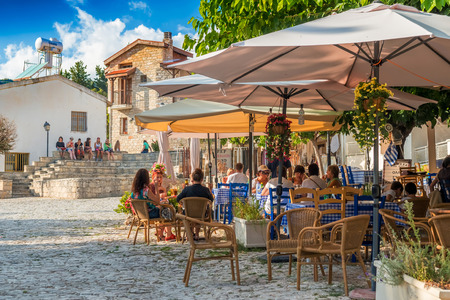 OMODOS, CYPRUS - OCTOBER 4, 2015: Street cafe's with tourists on OCTOBER 4 in Omodos village, Limassol District.のeditorial素材