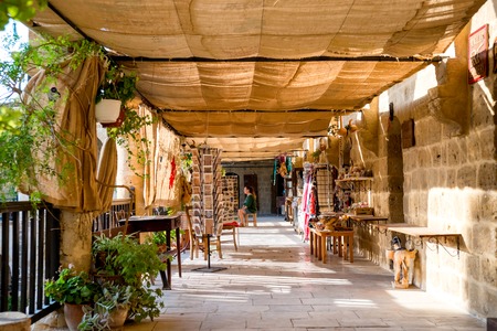 NICOSIA, CYPRUS - AUGUST 10, 2015: Buyuk Han The Great Inn Medieval caravanserai that turned into touristic center with an antique souvenir shops, craft workshops and cafes in Nicosia, Cyprus on August 10,2015のeditorial素材
