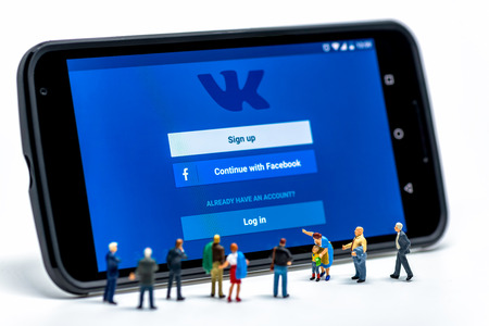 LIMASSOL, CYPRUS - DECEMBER 07, 2015: Group of people watching at Vkontakte application sign in page on smartphone. Social networking conceptのeditorial素材