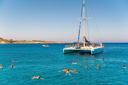 Catamaran loaded with tourists with blue sky and azure water on backgroundのeditorial素材