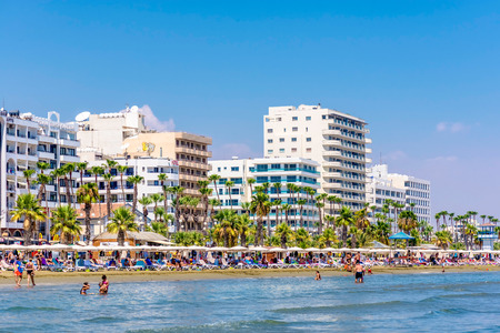 LARNACA, CYPRUS - AUGUST 27, 2016: Finikoudes Beach with the numerous hotels and cafes on the background.のeditorial素材