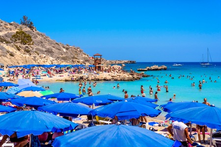 PROTARAS, CYPRUS - AUGUST 18, 2016: People relaxing and sunbathing at Konnos beachのeditorial素材