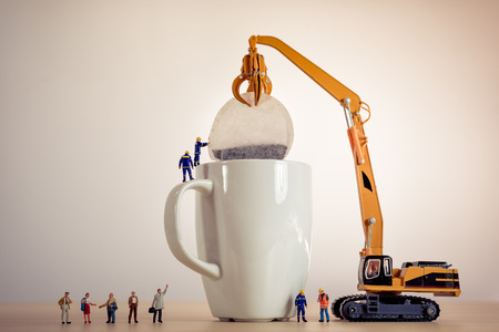 Miniature guys making tea.の写真素材