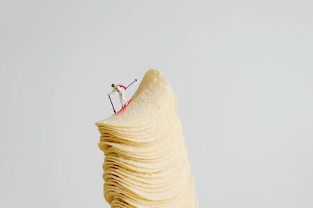 Skier skiing down from stack of potato chipsの写真素材