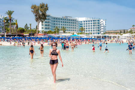 Ayia Napa, Cyprus - July 04, 2018: Tourists and locals enjoying the summer vacations on the Nissi beachのeditorial素材