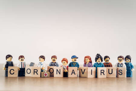 LIMASSOL, CYPRUS - March 27, 2020: Group of various people with 'coronavirus' sign