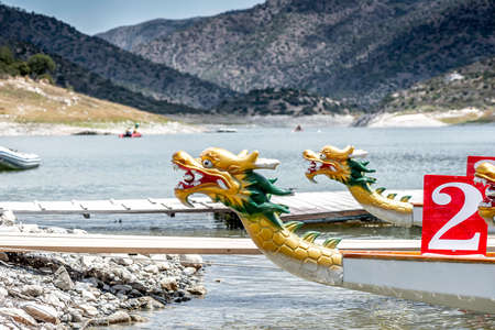 Dragon boats moored at wooden pier or jetty on the lakeの写真素材