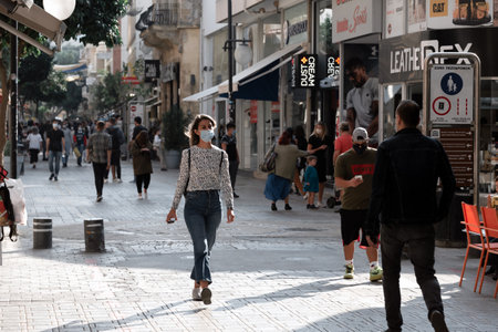 Nicosia, Cyprus - November 07, 2020: Woman in protective medical mask walking on the streets of Old Town of Nicosiaのeditorial素材