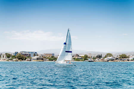 Sport sailing boat in front of a shore during regattaのeditorial素材