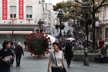 Belgrade, Serbia - March 13, 2020: Dangerous virus lurking around crowd of people on the city street. Pandemic concept. Illustrative Editorialのeditorial素材