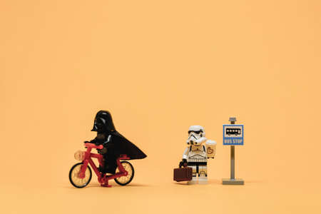 Darth Vader on bicycle passing public bus stop. Public transport concept. Illustrative editorial. September 02, 2021のeditorial素材